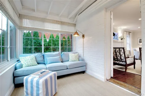 a living room with furniture and a floor to ceiling window