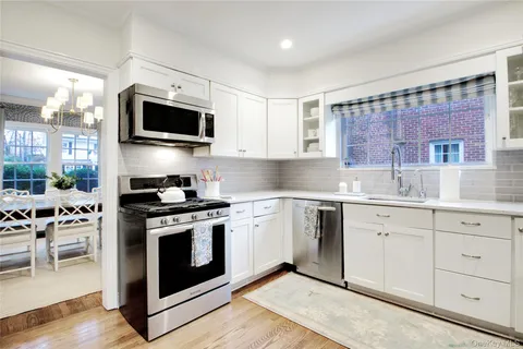 a kitchen with stainless steel appliances granite countertop a stove and a sink
