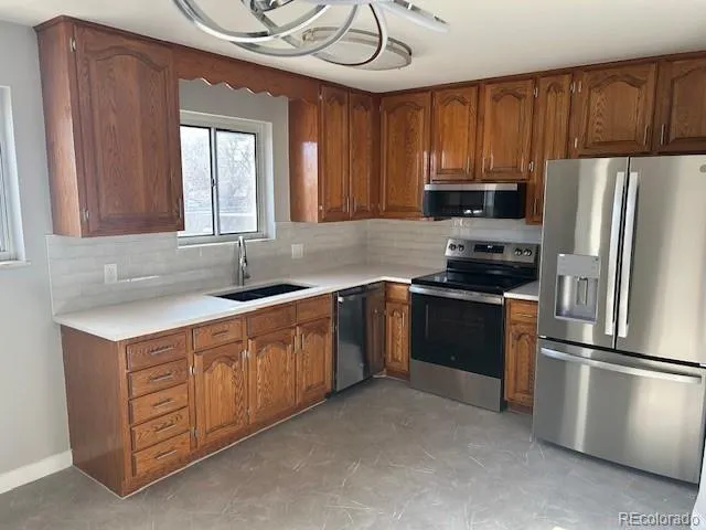 a kitchen with stainless steel appliances granite countertop a refrigerator sink and cabinets