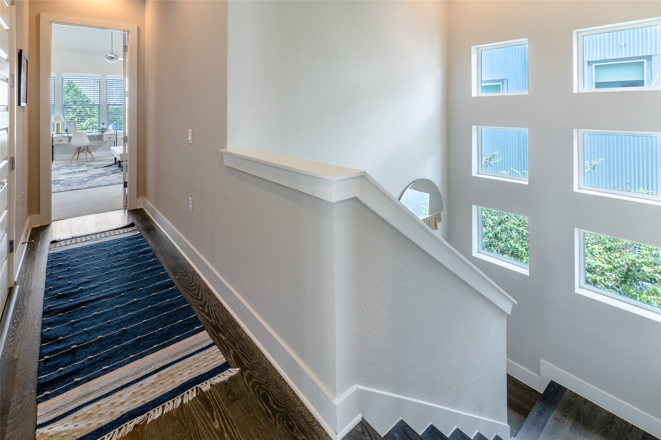 6025 Seville Drive Austin, TX 78724 - Photo 30 of 40 Wrapped staircase with transom window to fill with natural light leading to the primary bedroom