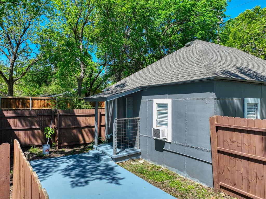 311 West McKinney Street Pilot Point, TX 76258 - Photo 26 of 33 The property features a gray exterior with a shingled roof