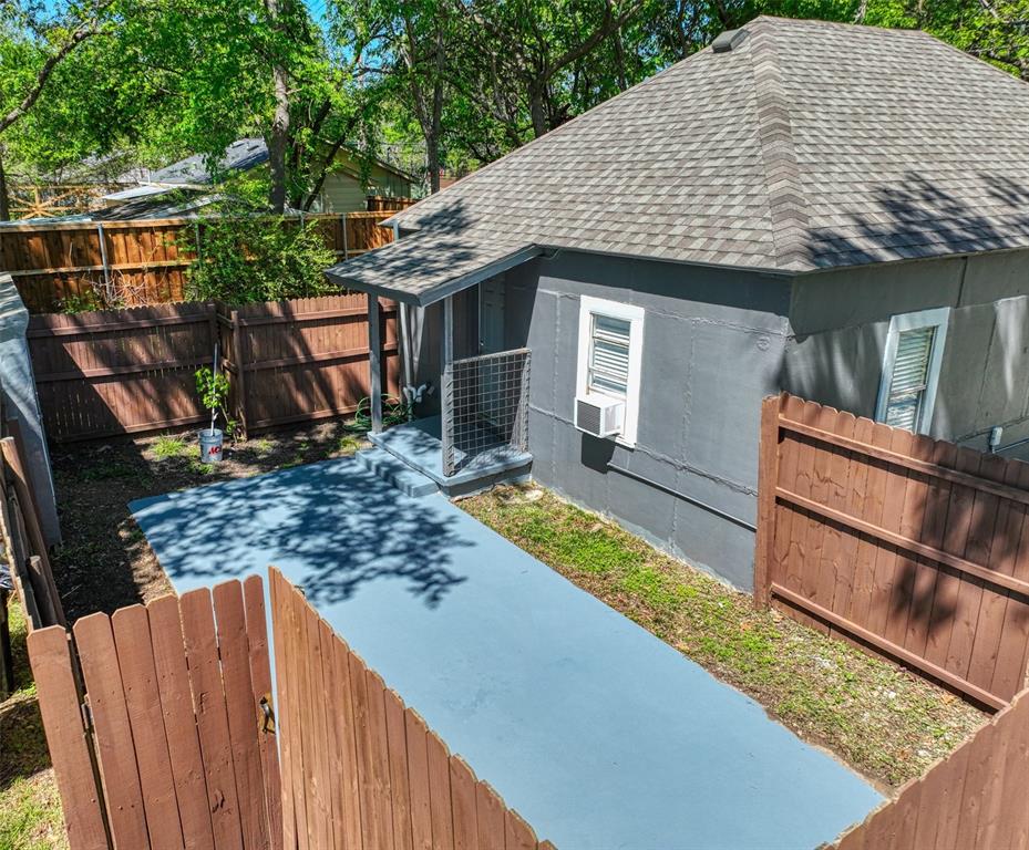 311 West McKinney Street Pilot Point, TX 76258 - Photo 29 of 33 The property features a grey exterior, a fenced yard, and a covered porch