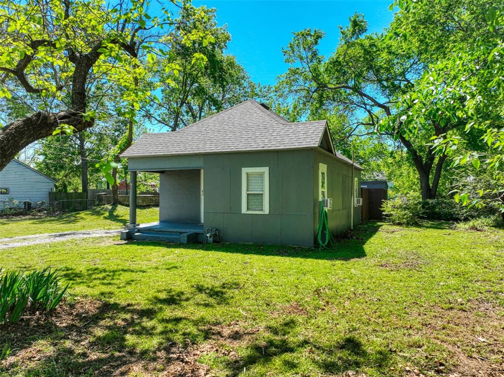 311 West McKinney Street Pilot Point, TX 76258 - Photo 30 of 33 The property features a grey exterior with white window trim and a covered front porch