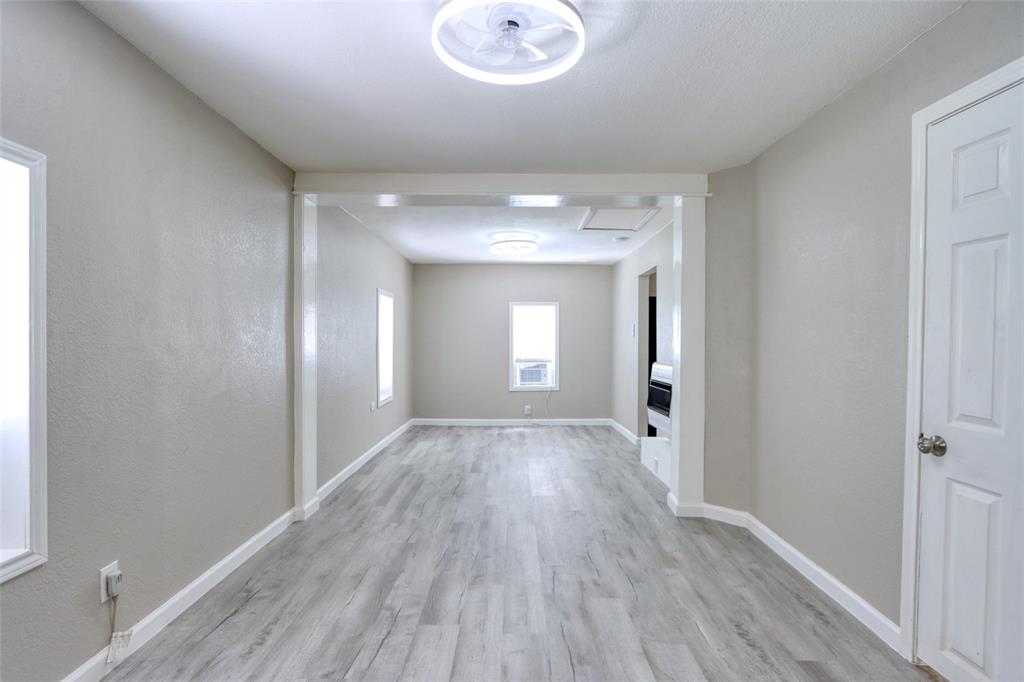 311 West McKinney Street Pilot Point, TX 76258 - Photo 4 of 33 The interior features light gray walls, white trim, and gray wood-look flooring throughout