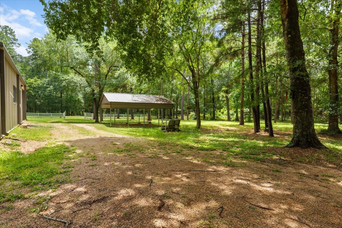 16375 Grand Flower Road Plantersville, TX 77363 - Photo 31 of 50 a view of a house with a yard