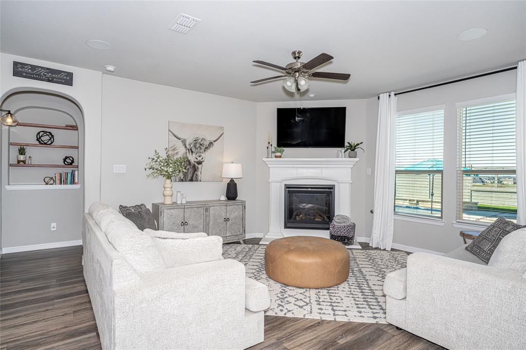 2404 Blackrail Court Argyle, TX 76226 - Photo 11 of 40 a living room with furniture a fireplace and a flat screen tv