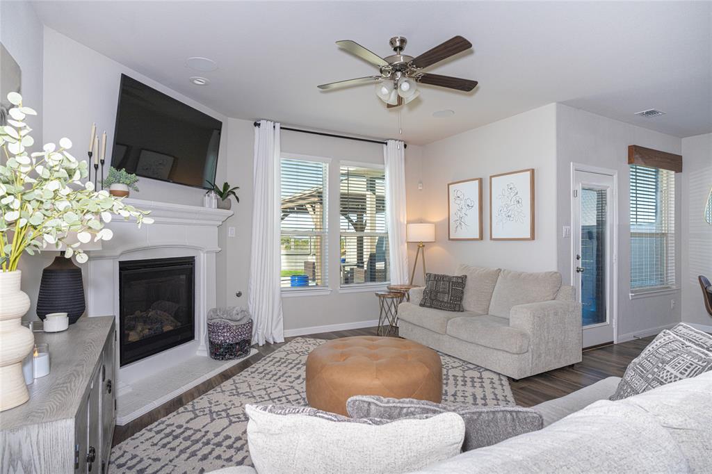 2404 Blackrail Court Argyle, TX 76226 - Photo 12 of 40 a living room with furniture a fireplace and a flat screen tv