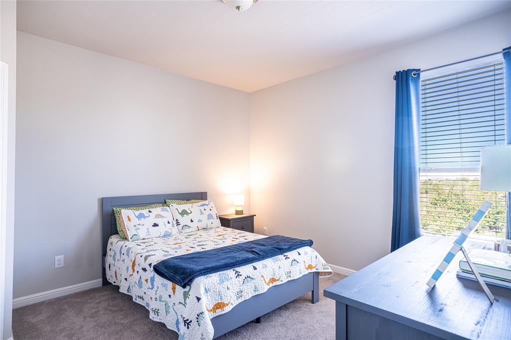 2404 Blackrail Court Argyle, TX 76226 - Photo 21 of 40 a bedroom with a bed and wooden floor