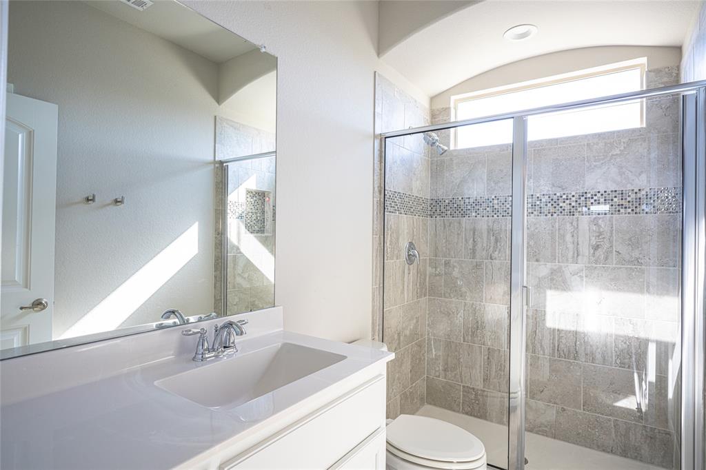 2404 Blackrail Court Argyle, TX 76226 - Photo 23 of 40 a bathroom with a sink toilet and shower
