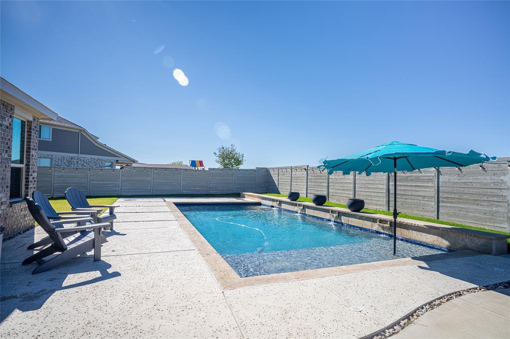 2404 Blackrail Court Argyle, TX 76226 - Photo 26 of 40 a view of a swimming pool with a lounge chair