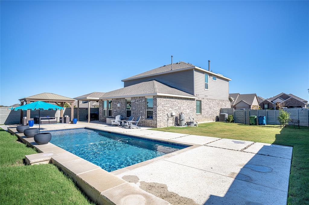 2404 Blackrail Court Argyle, TX 76226 - Photo 27 of 40 a front view of a house with a yard table and chairs