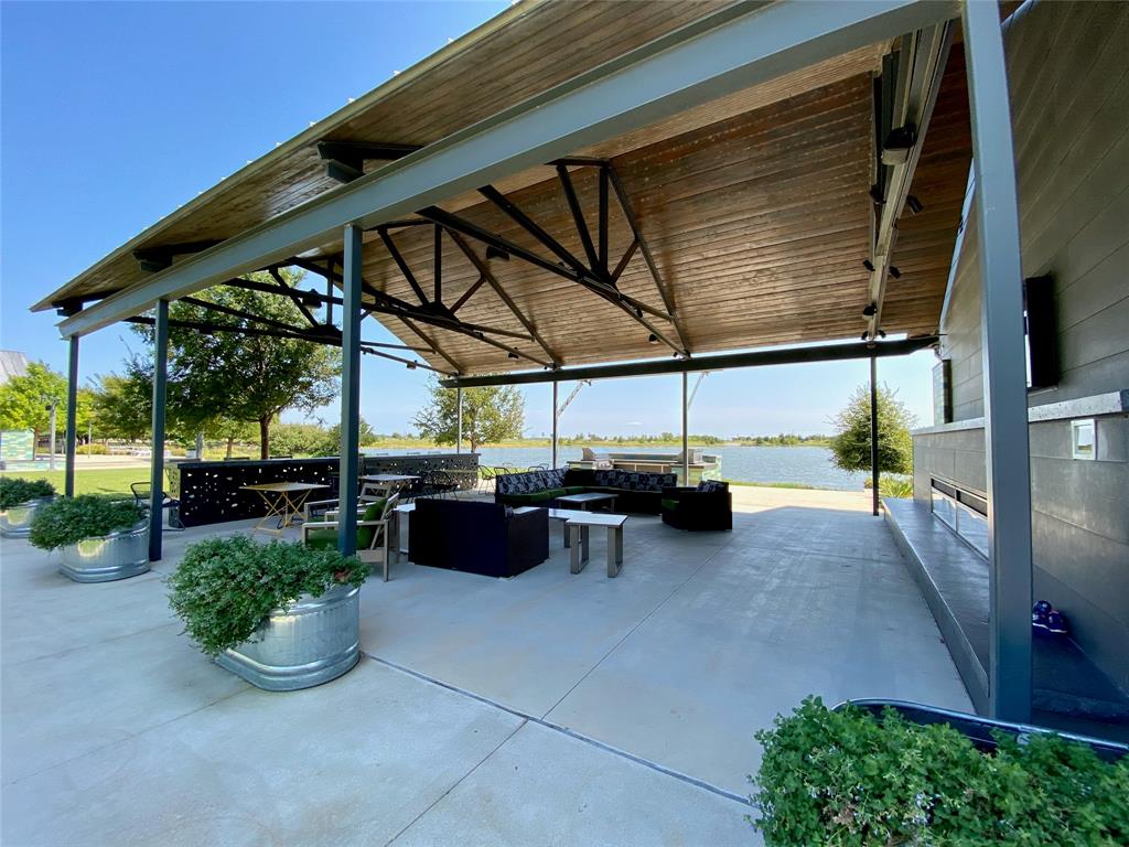 2404 Blackrail Court Argyle, TX 76226 - Photo 32 of 40 a view of a patio with table and chairs potted plants