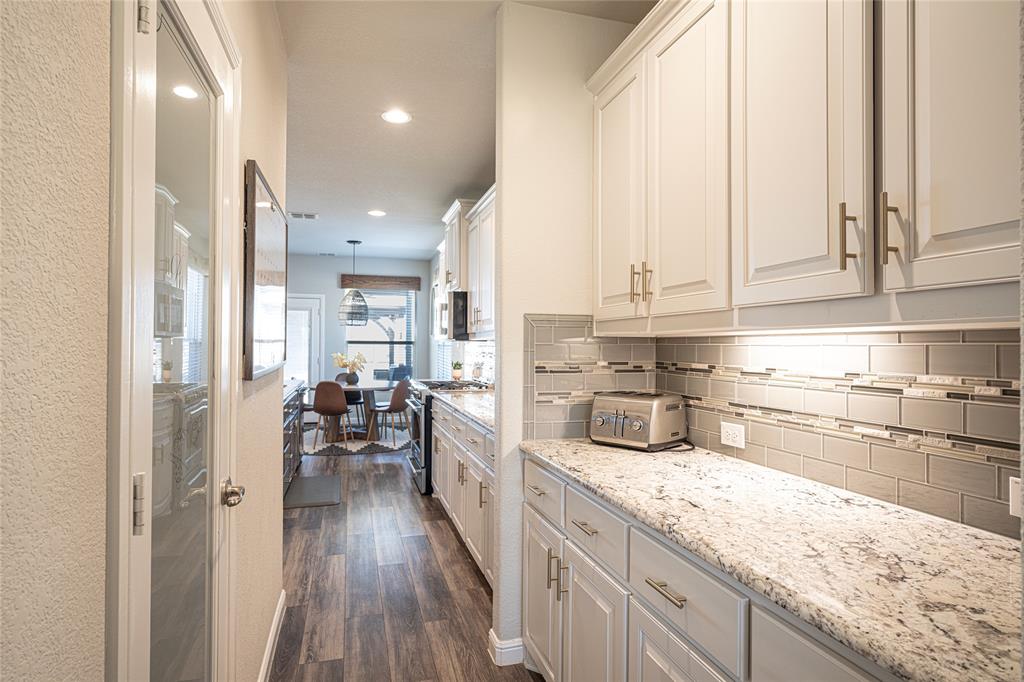 2404 Blackrail Court Argyle, TX 76226 - Photo 6 of 40 a kitchen with sink refrigerator and cabinets