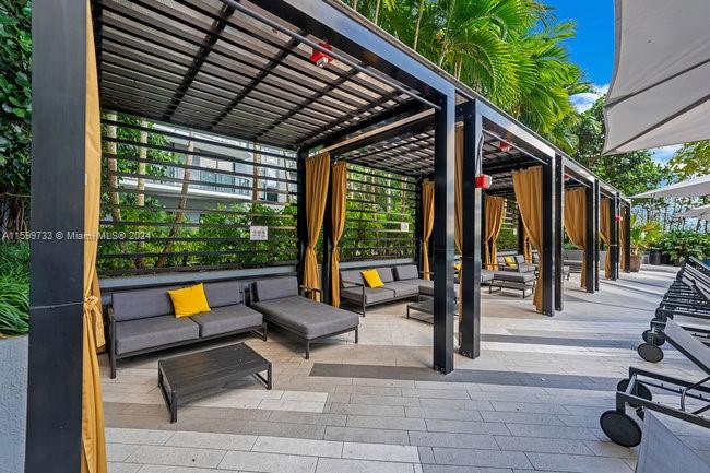 121 Northeast 34th Street, Unit L303 Miami, FL 33137 - Photo 22 of 31 a building outdoor space with patio furniture and wooden floor