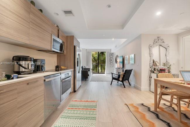 121 Northeast 34th Street, Unit L303 Miami, FL 33137 - Photo 7 of 31 a kitchen with sink cabinets and counter top space