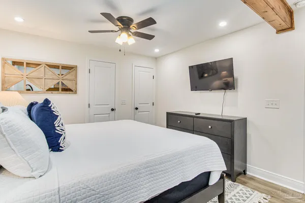 a bedroom with a bed and a flat screen tv