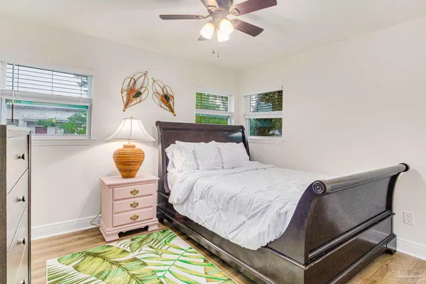 a bed room with a bed and a chair