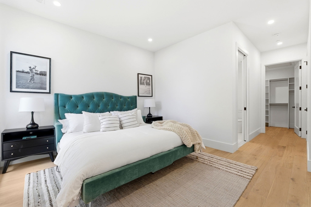 1114 Beacon Street, Unit 207 Newton, MA 02461 - Photo 11 of 29 a bedroom with a bed and a walk in closet
