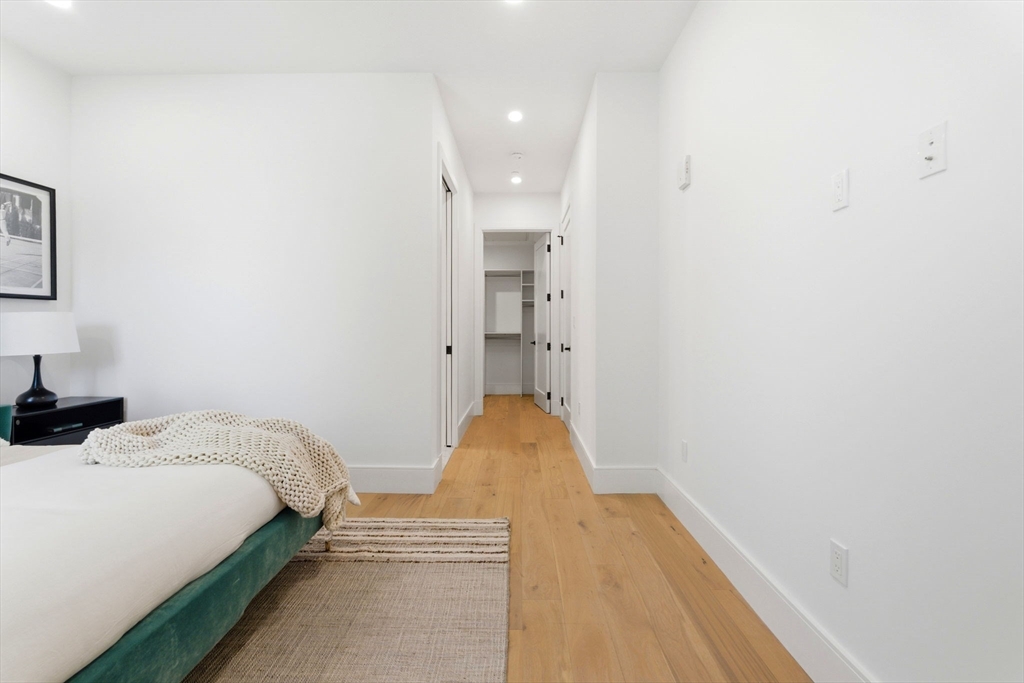 1114 Beacon Street, Unit 207 Newton, MA 02461 - Photo 12 of 29 a bedroom with a bed and a painting on the wall