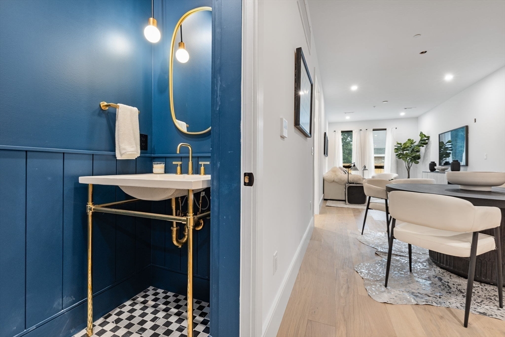 1114 Beacon Street, Unit 207 Newton, MA 02461 - Photo 16 of 38 a kitchen with a sink cabinets and dining table