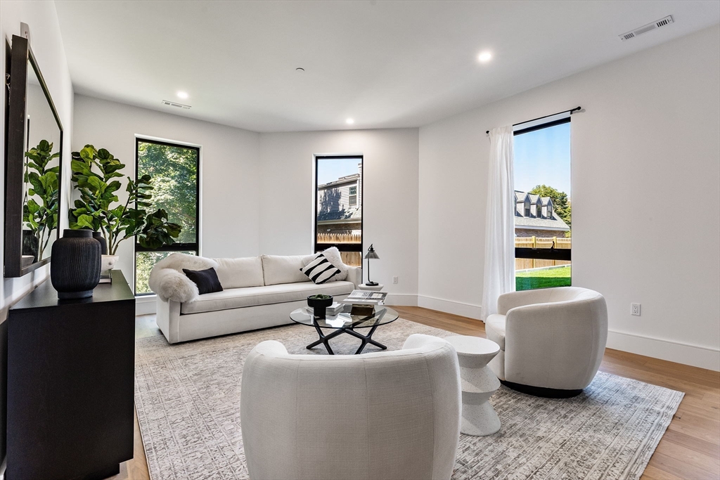 1114 Beacon Street, Unit 207 Newton, MA 02461 - Photo 20 of 38 a living room with furniture and a window