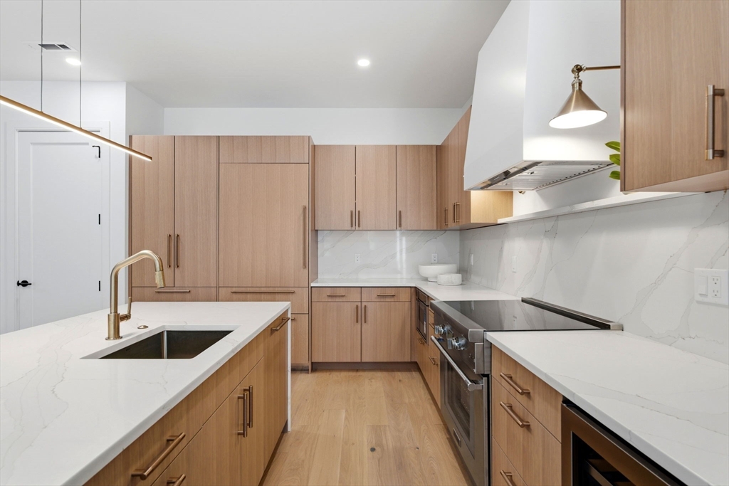 1114 Beacon Street, Unit 207 Newton, MA 02461 - Photo 2 of 29 a kitchen with a sink a stove and cabinets