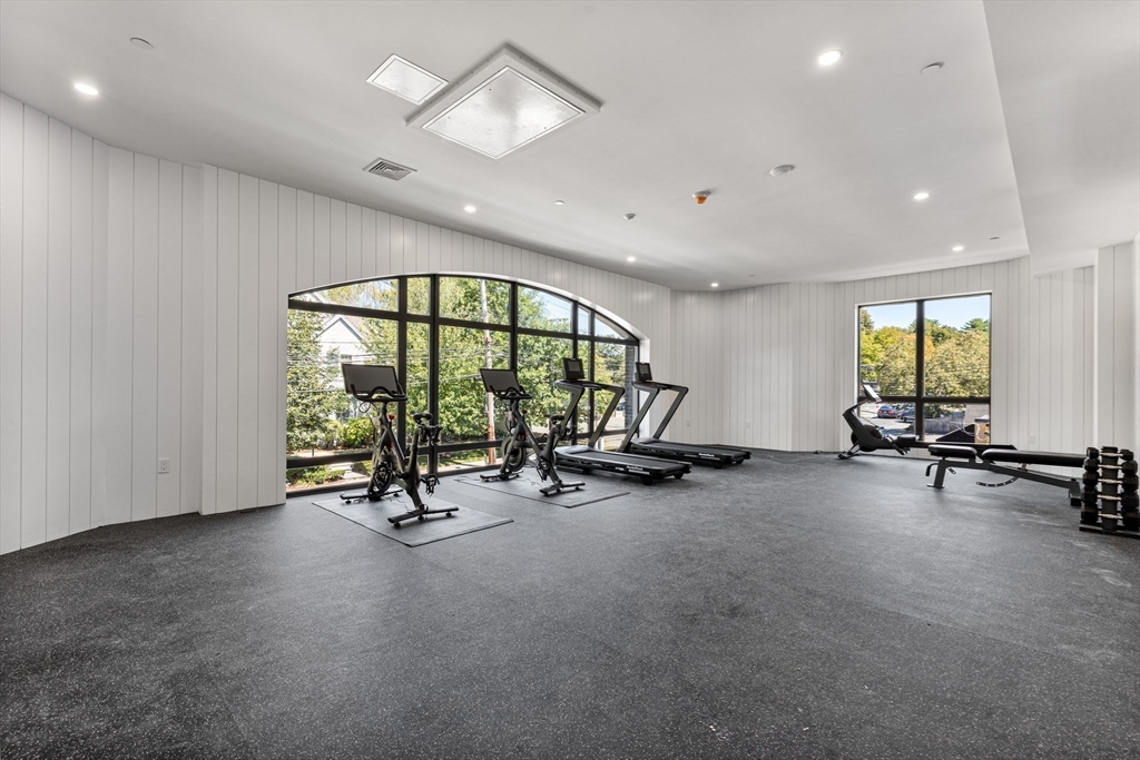 1114 Beacon Street, Unit 207 Newton, MA 02461 - Photo 23 of 29 a view of a room with gym equipment and a large window