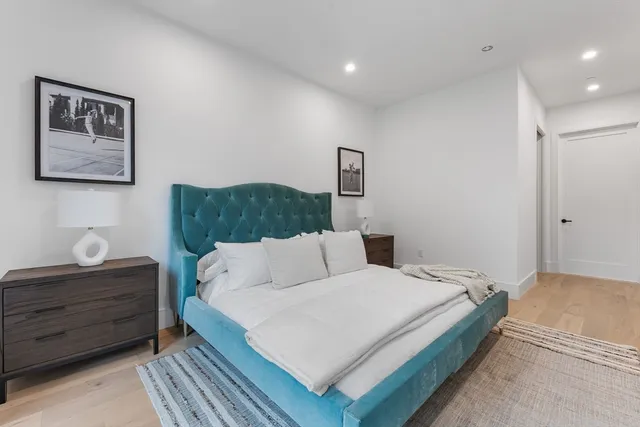 a spacious bedroom with a bed and a window