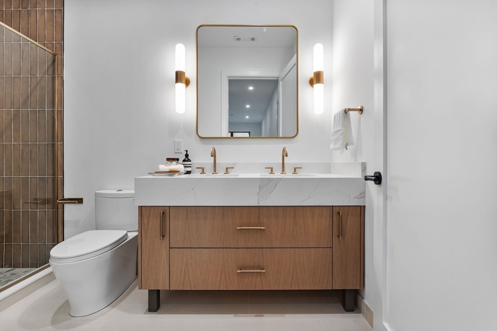 1114 Beacon Street, Unit 207 Newton, MA 02461 - Photo 28 of 38 a bathroom with a sink vanity and a mirror