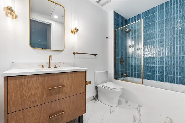 a bathroom with a shower toilet and sink