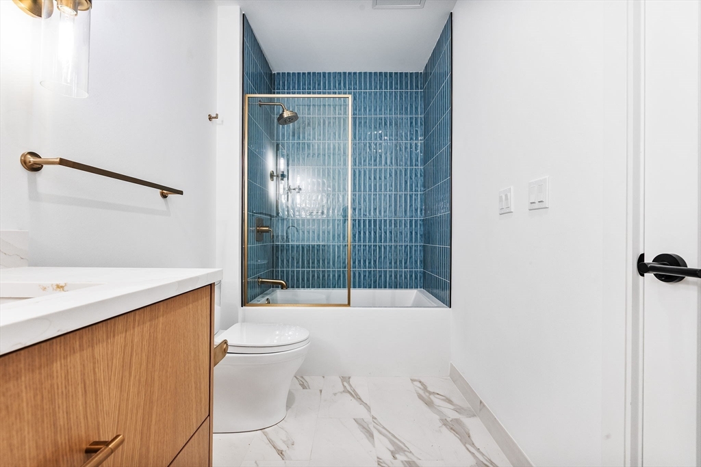 1114 Beacon Street, Unit 207 Newton, MA 02461 - Photo 31 of 38 a bathroom with a shower toilet and sink