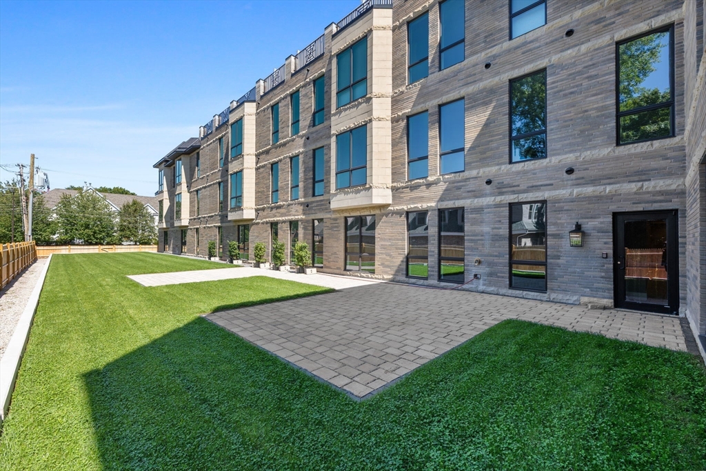 1114 Beacon Street, Unit 207 Newton, MA 02461 - Photo 34 of 38 a view of building with a yard