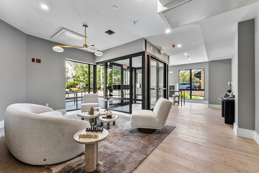 1114 Beacon Street, Unit 207 Newton, MA 02461 - Photo 5 of 38 a living room with furniture and a large window