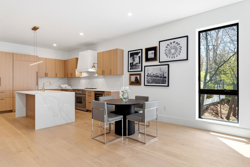 1114 Beacon Street, Unit 207 Newton, MA 02461 - Photo 6 of 29 a living room with stainless steel appliances kitchen island granite countertop furniture and a view of kitchen