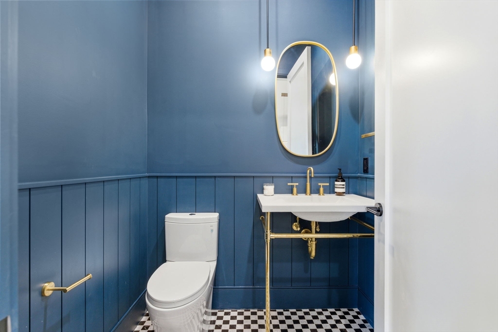 1114 Beacon Street, Unit 207 Newton, MA 02461 - Photo 9 of 29 a bathroom with a sink a toilet and a mirror