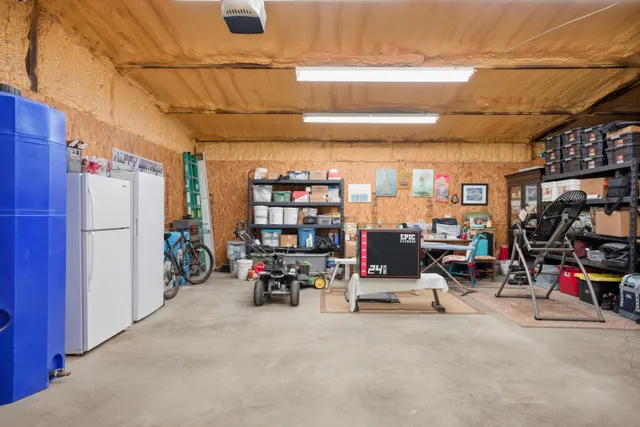 a kitchen with stainless steel appliances kitchen island granite countertop a refrigerator and microwave