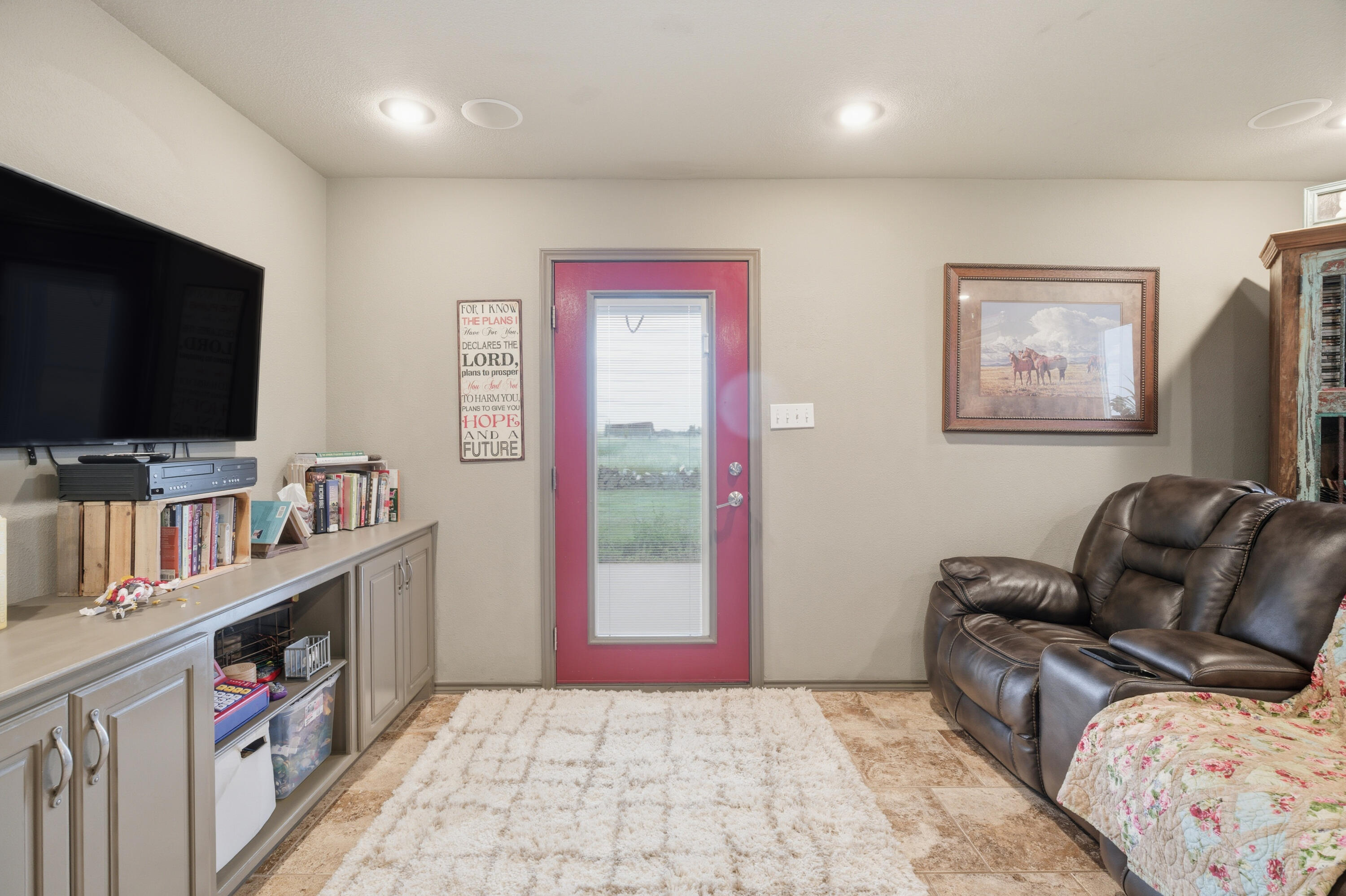 672 Cr M Road New Home, TX 79381 - Photo 18 of 30 a bedroom with furniture and a flat screen tv