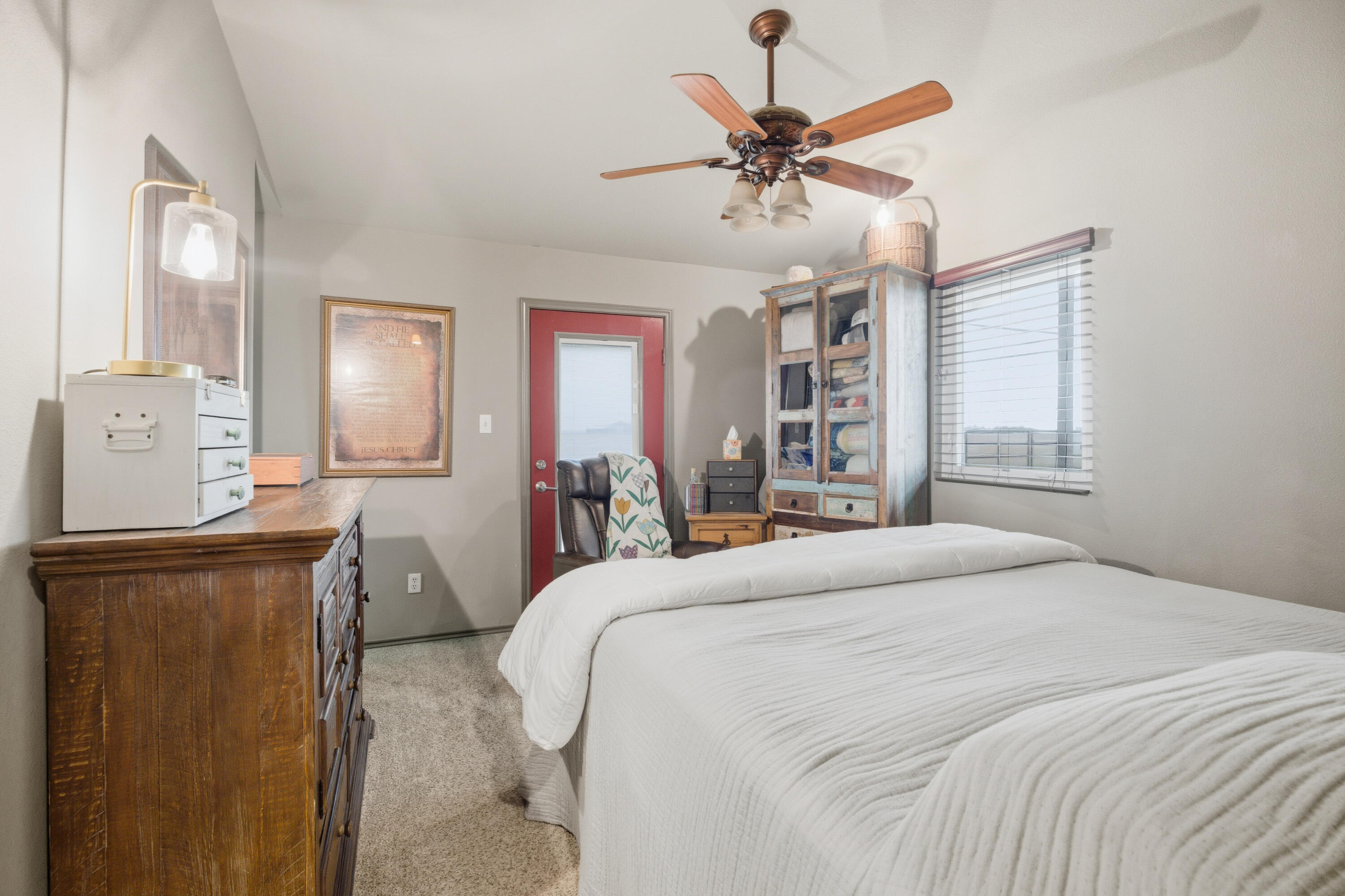672 Cr M Road New Home, TX 79381 - Photo 25 of 30 a bedroom with a bed a dresser and potted plant