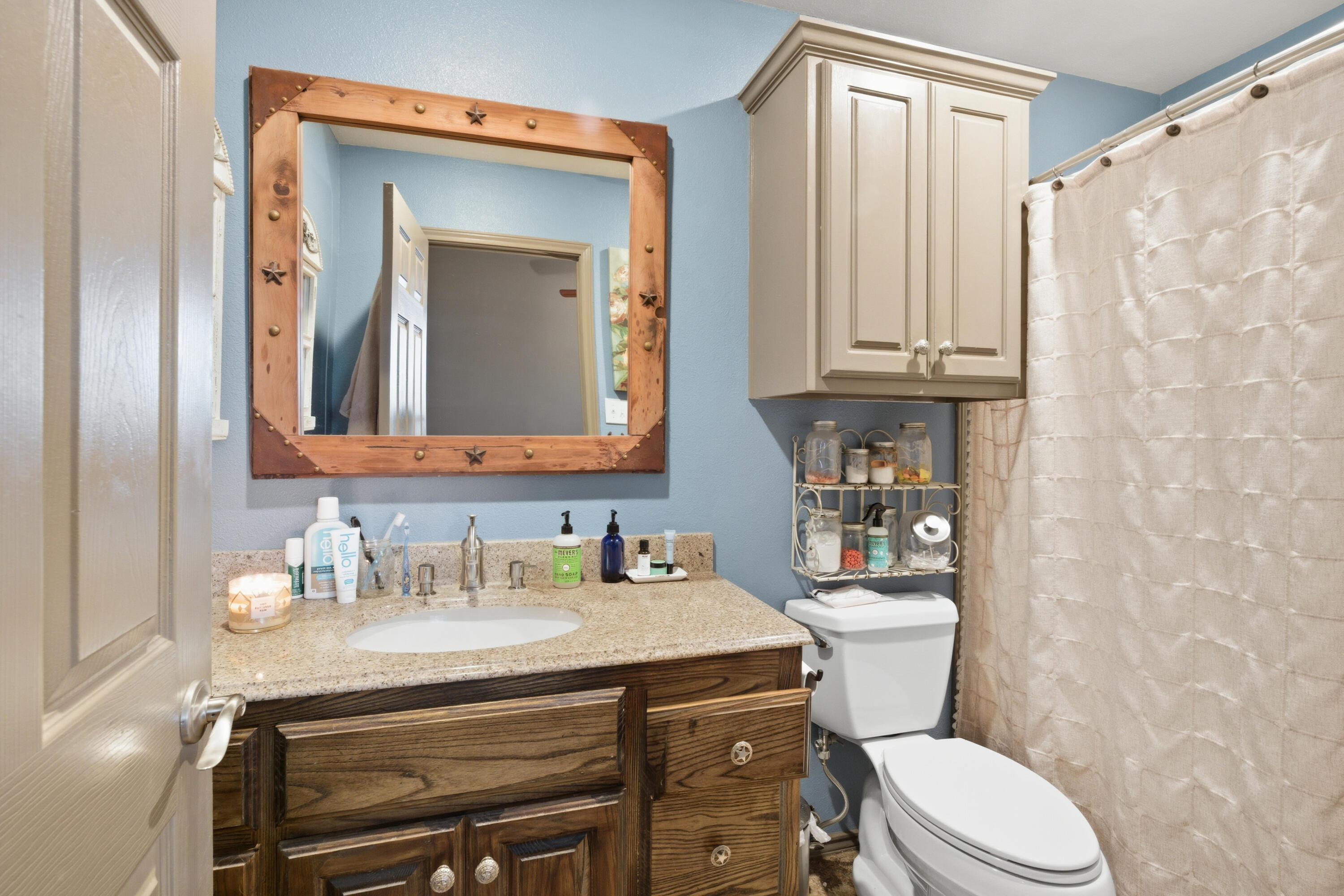 672 Cr M Road New Home, TX 79381 - Photo 26 of 30 a bathroom with a toilet a sink and a mirror