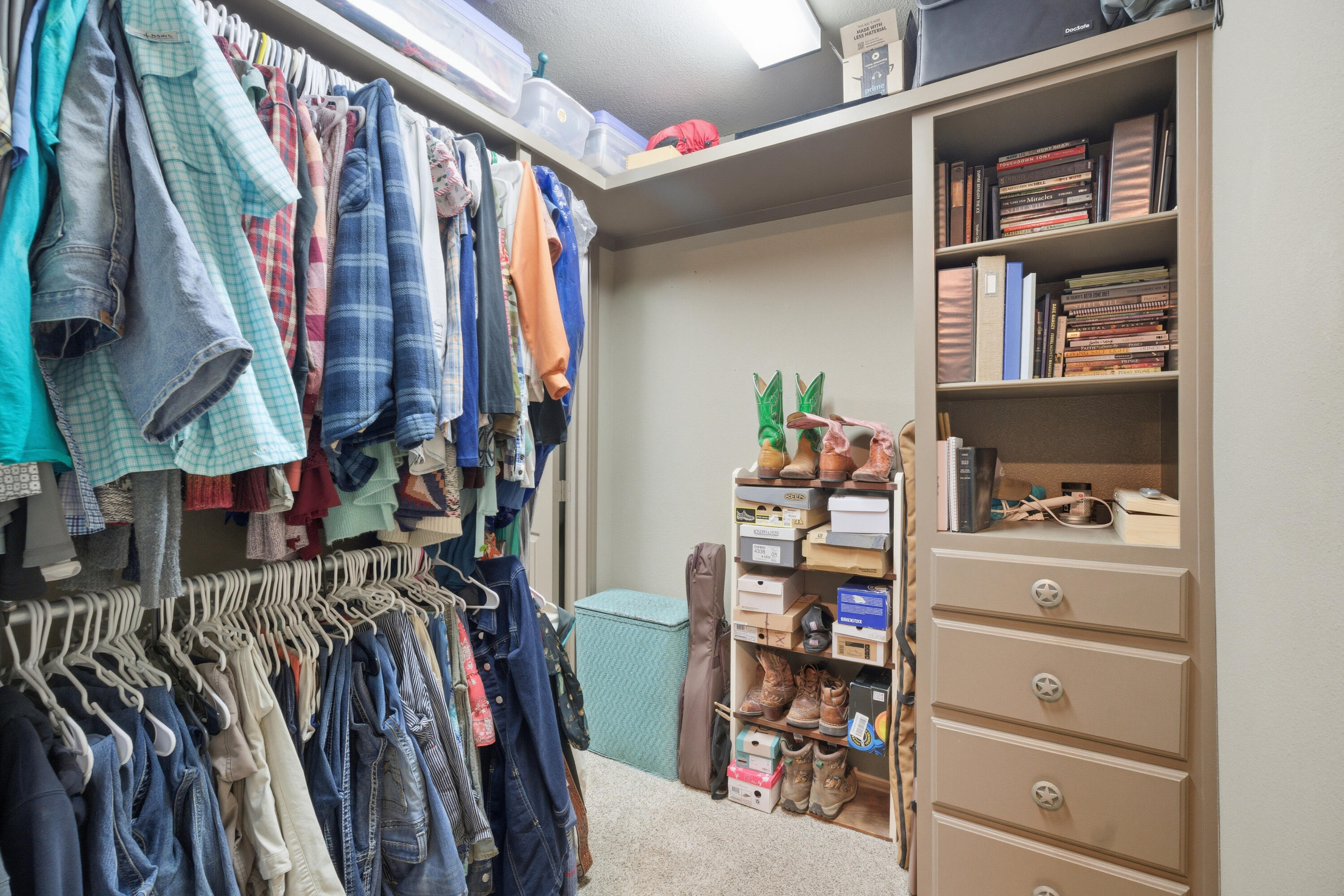 672 Cr M Road New Home, TX 79381 - Photo 27 of 30 a view of walk in closet with clothes and shoes