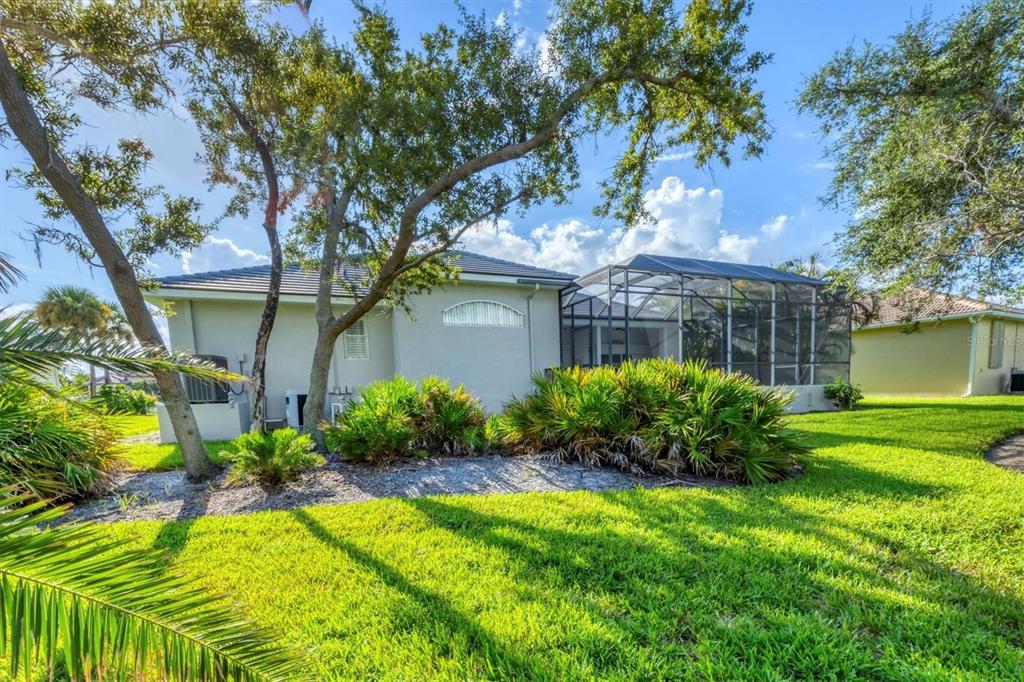 4 Windward Way Placida, FL 33946 - Photo 36 of 39 a view of a house with a yard and a large tree