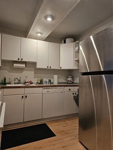 a view of stove top oven and cabinets