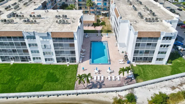an aerial view of residential houses with yard and ocean view