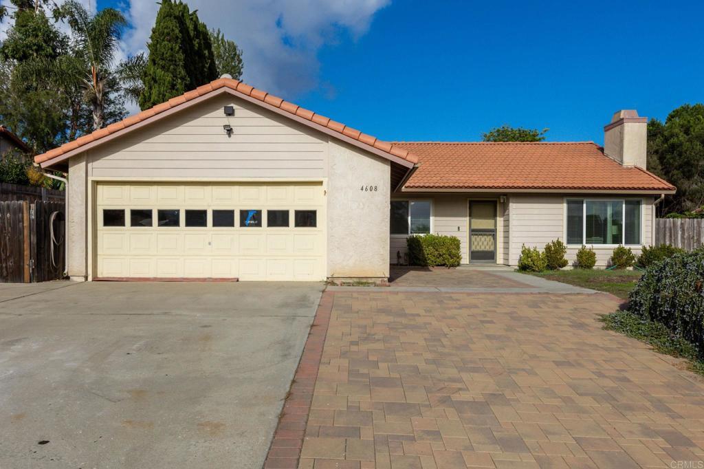4608 Briar Ridge Road Oceanside, CA 92056 - Photo 1 of 1 a view of a house with a yard and garage
