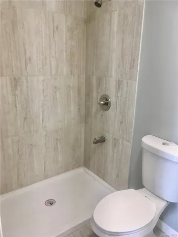 a bathroom with a toilet and a shower curtain