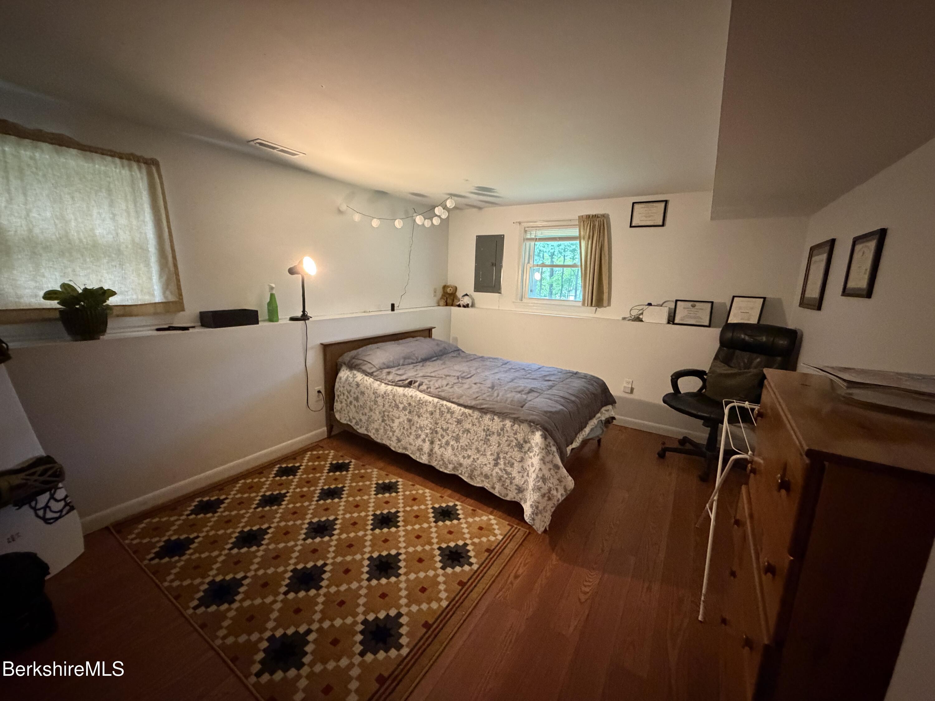 20 Sullivan Lane Lenox, MA 01240 - Photo 14 of 23 a bedroom with a bed and wooden floor