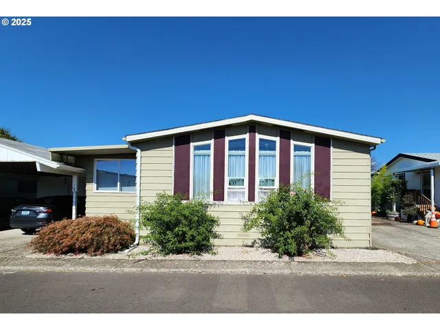 a room with lots of furniture and lots of potted plants