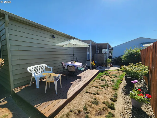 a patio with wooden table and chairs