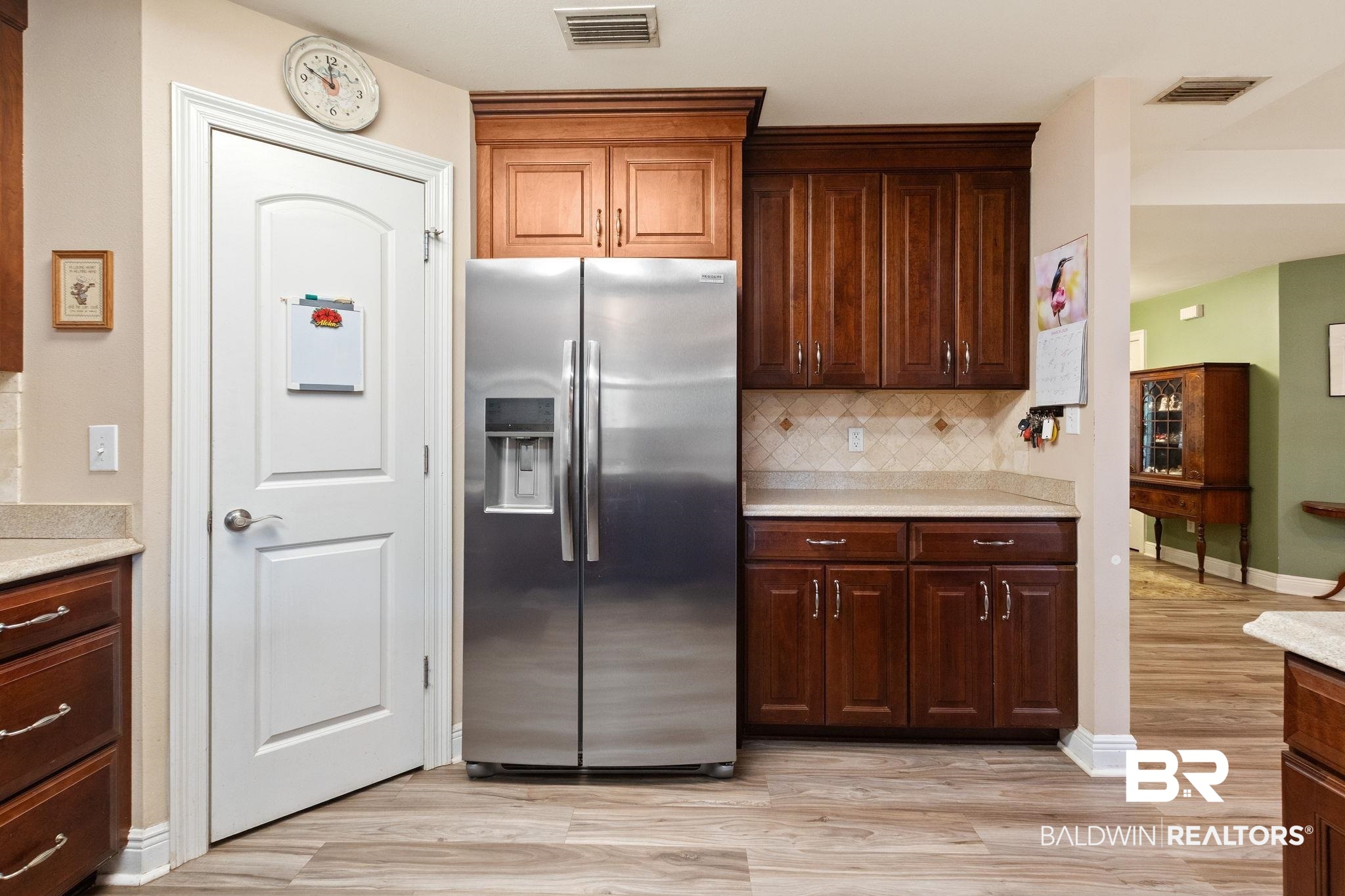 24250 Hack Road Bay Minette, AL 36507 - Photo 17 of 88 Kitchen with stainless steel fridge, light wood-type flooring, tasteful backsplash, and light stone countertops