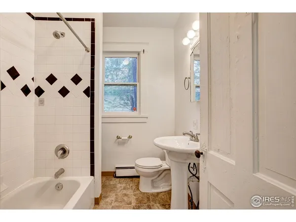 a bathroom with a sink a toilet a shower and a mirror